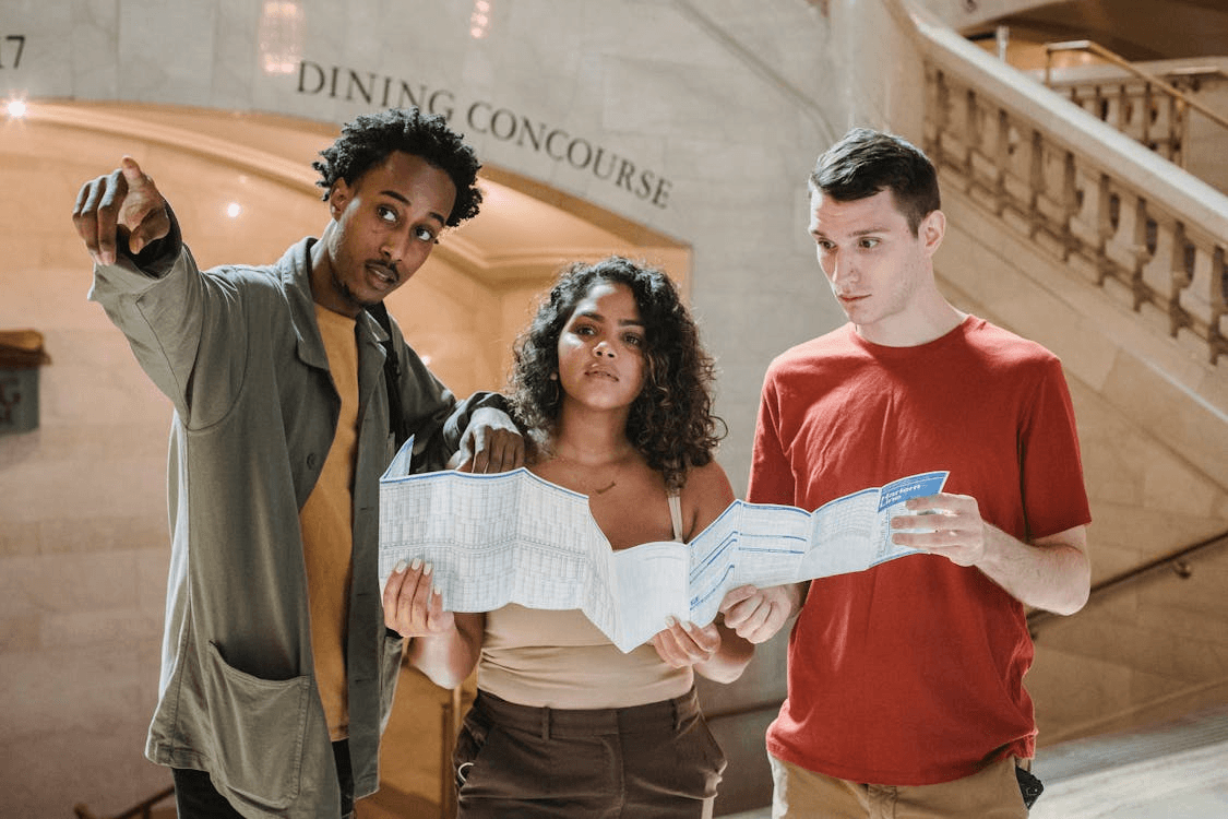 A local guide helping travelers read a city map