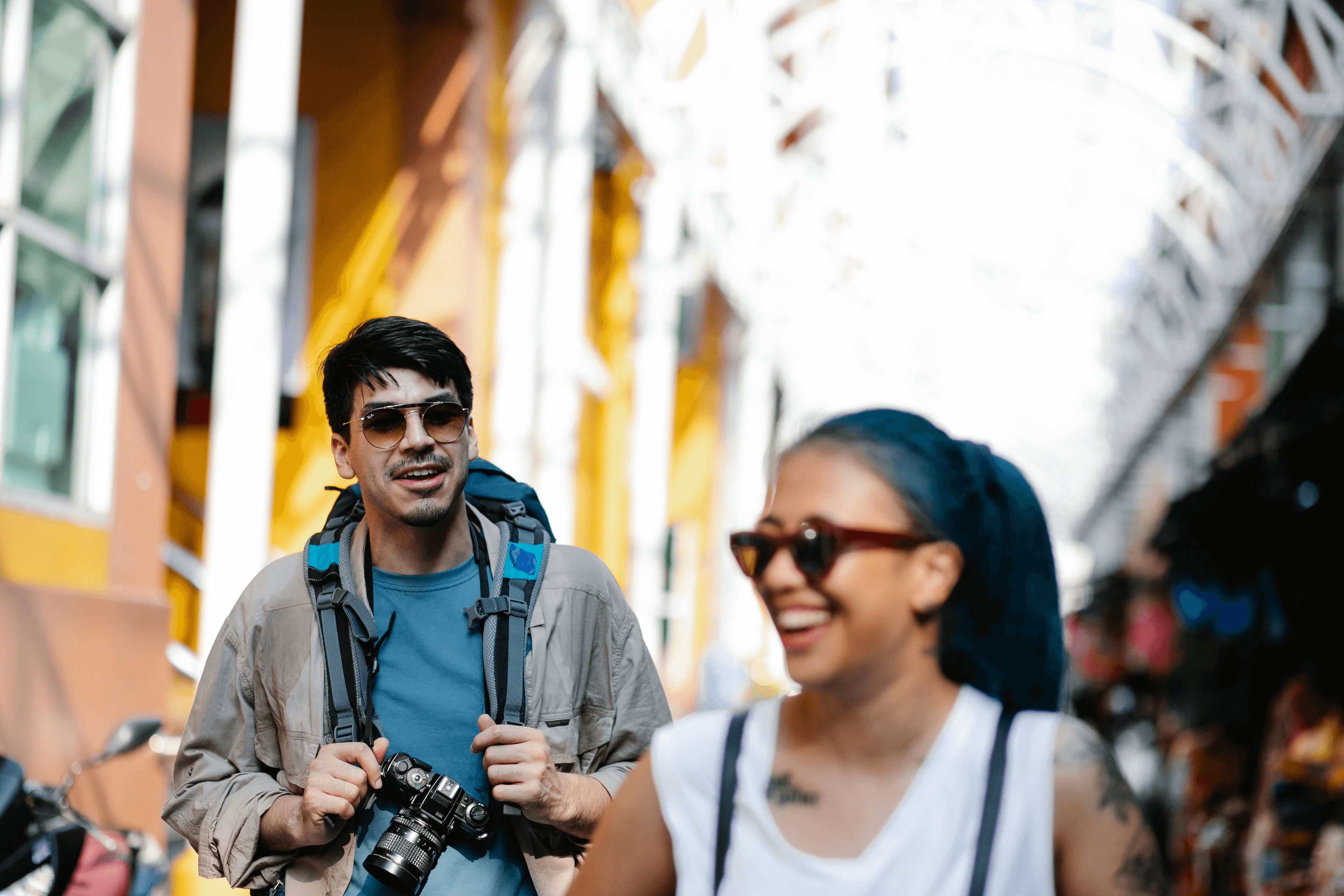 A local guide walking with travelers through a colorful city street